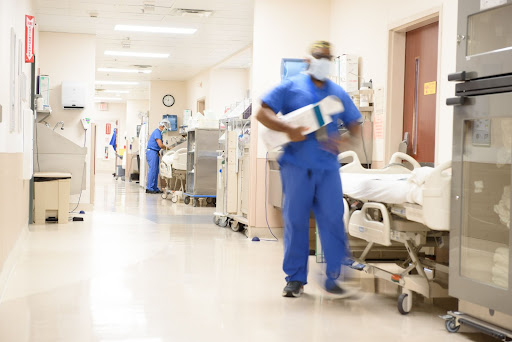 Image of a busy surgical floor with doctors in the hallway.