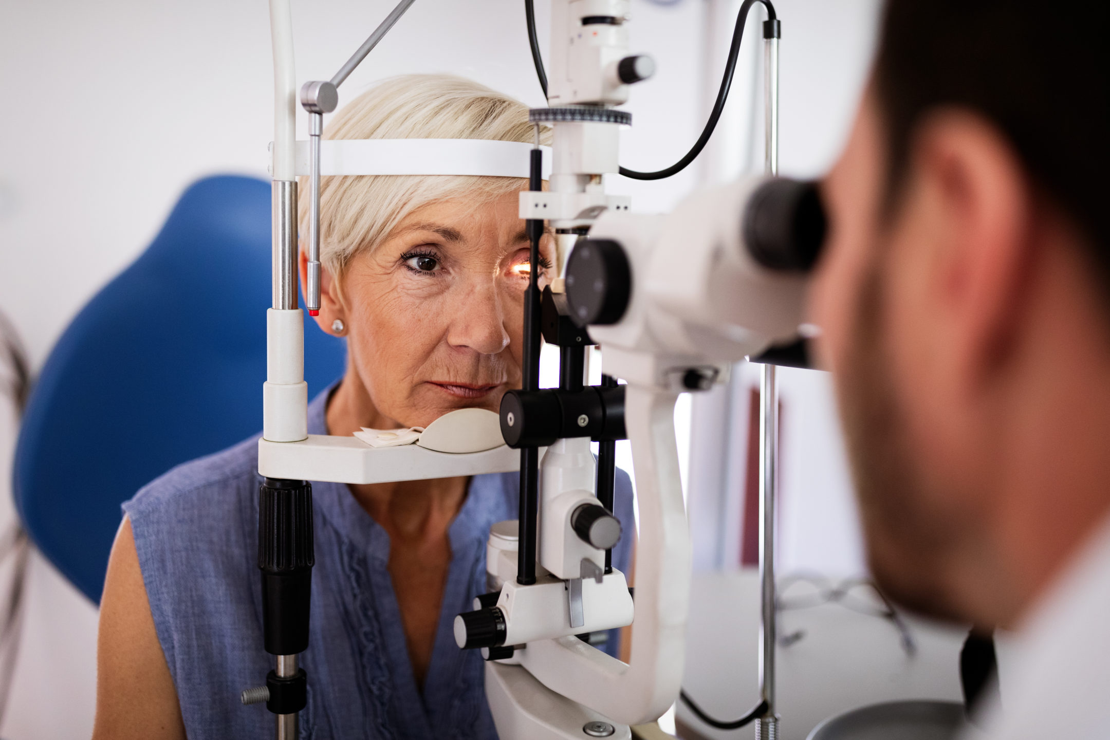 An ophthalmologist performs an eye exam.