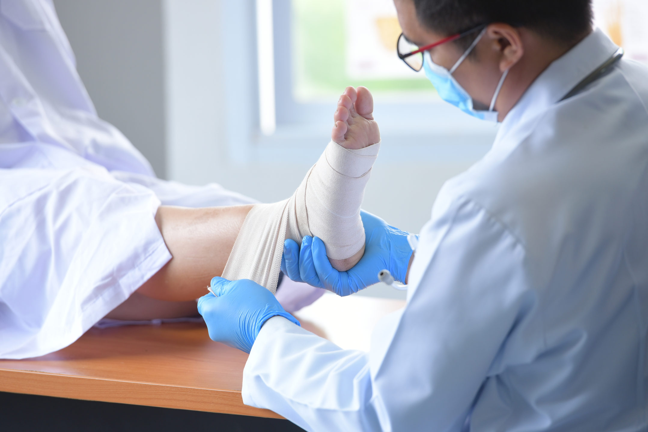 Image of podiatrist wrapping a patient’s foot.